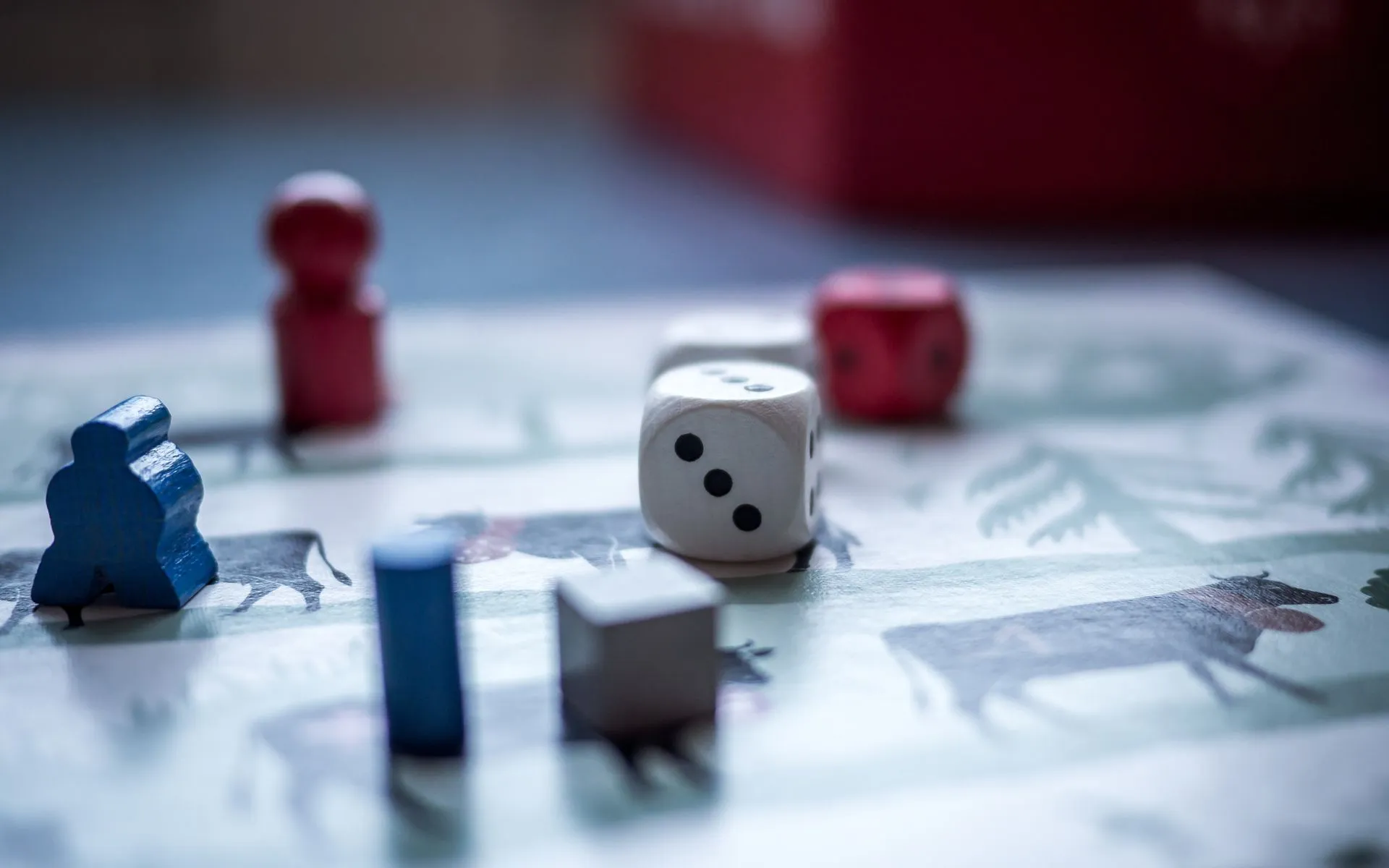 Strategy board game with wooden pieces and dice mid-play